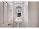 Half bathroom featuring a pedestal sink and decorative mirror at , Henderson, NV 89011