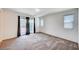 Spacious bedroom with neutral carpet, a large sliding glass door, and natural light at , Henderson, NV 89011