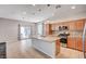 Open kitchen with stainless appliances, island, tile floors, pendant lighting, and sliding glass doors at , Henderson, NV 89011