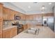 Bright kitchen features stainless steel appliances, granite counters, mosaic tile backsplash, and wooden cabinetry at , Henderson, NV 89011