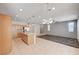 Open-concept kitchen boasts wooden cabinets, stainless steel appliances, an island, and pendant lighting at , Henderson, NV 89011