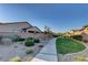 Landscaped community walkway offers manicured plants and lawn, set against a backdrop of neighborhood houses at , Henderson, NV 89011