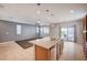 Open floor plan with tile floors, ceiling fan, and kitchen island with granite countertop at , Henderson, NV 89011
