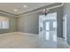 Spacious living room with stone floors and a decorative chandelier at 10260 Hawks Wing St, Las Vegas, NV 89178