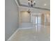 Bright living room with open floorplan, marble floors, and columned archways at 10260 Hawks Wing St, Las Vegas, NV 89178