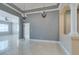 Open living room with marble floors, chandeliers, and views into adjacent rooms at 10260 Hawks Wing St, Las Vegas, NV 89178