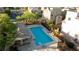 Aerial of community pool with a hot tub, gazebo, chairs and manicured green spaces in a residential community at 10733 Red Badge Ave, Las Vegas, NV 89166