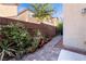 Backyard features a brick-paved patio, plants, greenery, and privacy wall, creating a cozy outdoor space at 10733 Red Badge Ave, Las Vegas, NV 89166