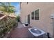 Comfortable backyard with brick-paved area, plants, AC unit, and access to the house with a glass sliding door at 10733 Red Badge Ave, Las Vegas, NV 89166