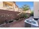 Cozy backyard featuring an AC unit, brick-paved area, privacy wall, and plants, perfect for relaxation at 10733 Red Badge Ave, Las Vegas, NV 89166