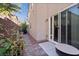 Backyard space featuring a glass sliding door to the house, plants and a brick-paved patio at 10733 Red Badge Ave, Las Vegas, NV 89166