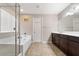 Bright bathroom featuring a separate glass enclosed shower and a soaking tub, plus a dark wood vanity at 10733 Red Badge Ave, Las Vegas, NV 89166