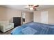 Comfortable bedroom features a ceiling fan, chair, dresser, and doorway to an adjoining bathroom at 10733 Red Badge Ave, Las Vegas, NV 89166