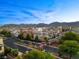 Scenic view of a neighborhood with mountain backdrop and well-maintained landscaping under a blue sky at 10733 Red Badge Ave, Las Vegas, NV 89166