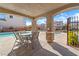 Community pool with covered seating area with table and chairs, perfect for outdoor dining and relaxation at 10733 Red Badge Ave, Las Vegas, NV 89166