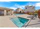 Community pool area featuring a hot tub, lounge chairs, covered seating area and well-maintained landscaping at 10733 Red Badge Ave, Las Vegas, NV 89166
