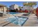 Inviting community pool area with a hot tub, lounge chairs and outdoor dining space for relaxing and socializing at 10733 Red Badge Ave, Las Vegas, NV 89166