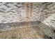 Close up of a granite countertop with a mosaic backsplash and an electrical outlet at 10733 Red Badge Ave, Las Vegas, NV 89166