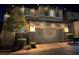 Two story home with a two car garage adorned with holiday lights on a dark evening at 10733 Red Badge Ave, Las Vegas, NV 89166