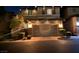 Two story home with a two car garage adorned with holiday lights on a dark evening at 10733 Red Badge Ave, Las Vegas, NV 89166