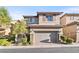 Charming two-story home featuring neutral stucco, brick accents, and a two-car garage at 10733 Red Badge Ave, Las Vegas, NV 89166