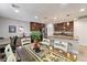 Open-concept kitchen and dining area with dark cabinetry, stainless steel appliances, and modern decor at 10733 Red Badge Ave, Las Vegas, NV 89166