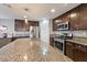 Kitchen with a center island, stainless steel appliances and dark wood cabinets and drawers at 10733 Red Badge Ave, Las Vegas, NV 89166