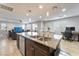 Kitchen featuring a center island, stainless steel appliances, dark wood cabinets and an adjoining living space at 10733 Red Badge Ave, Las Vegas, NV 89166