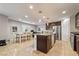 Open kitchen features granite countertops, stainless steel appliances and tiled floor at 10733 Red Badge Ave, Las Vegas, NV 89166