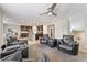 Spacious living room adjacent to the open-concept kitchen, and features comfortable leather chairs at 10733 Red Badge Ave, Las Vegas, NV 89166