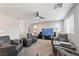 Open living room has carpeting, recessed lights, a ceiling fan and theater style leather furniture at 10733 Red Badge Ave, Las Vegas, NV 89166