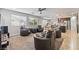 Cozy living room that opens to the kitchen and dining area features many leather chairs and natural light at 10733 Red Badge Ave, Las Vegas, NV 89166