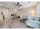 Inviting living room showcasing wood floors, comfortable seating, and a staircase with access to the front door at 10733 Red Badge Ave, Las Vegas, NV 89166