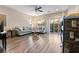 Bright living room with wood floors, neutral walls, ceiling fan, sliding glass doors and comfortable seating at 10733 Red Badge Ave, Las Vegas, NV 89166