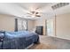 Bright main bedroom with a ceiling fan, a dresser, and ensuite bathroom access at 10733 Red Badge Ave, Las Vegas, NV 89166