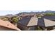A neighborhood rooftop view overlooking the mountain range and features multiple houses at 10733 Red Badge Ave, Las Vegas, NV 89166