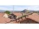 A scenic view of the city and surrounding mountains, captured from above rooftops in a quiet neighborhood at 10733 Red Badge Ave, Las Vegas, NV 89166