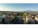 An aerial neighborhood shot features lush landscaping, well-maintained homes, and mountain views at 10733 Red Badge Ave, Las Vegas, NV 89166