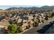 An aerial view shows a well maintained neighborhood with lush landscaping and mountain views at 10733 Red Badge Ave, Las Vegas, NV 89166