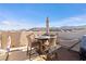 Enjoy the outdoor living space with mountain views on this rooftop patio with dining and lounging furniture at 10733 Red Badge Ave, Las Vegas, NV 89166