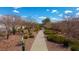 Picturesque walking path surrounded by desert landscaping and mature trees in a residential area at 10733 Red Badge Ave, Las Vegas, NV 89166