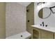 Modern bathroom with stylish vanity, mirror, and tiled shower at 1108 Putnam Ave, North Las Vegas, NV 89030