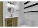Modern bathroom with stylish vanity, mirror, and shelves at 1108 Putnam Ave, North Las Vegas, NV 89030