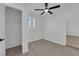 Bright bedroom featuring carpet floors, a ceiling fan, and ample natural light through the windows at 1108 Putnam Ave, North Las Vegas, NV 89030