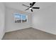 Bedroom with neutral carpet, large window, and a ceiling fan at 1108 Putnam Ave, North Las Vegas, NV 89030