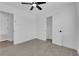 Bright bedroom featuring neutral carpet, a ceiling fan, and a closet for ample storage space at 1108 Putnam Ave, North Las Vegas, NV 89030