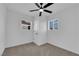 Cozy bedroom featuring carpet floors, a ceiling fan, and ample natural light through the windows at 1108 Putnam Ave, North Las Vegas, NV 89030