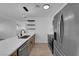 Bright kitchen features stainless steel appliances, quartz countertops, modern cabinets, and light wood flooring at 1108 Putnam Ave, North Las Vegas, NV 89030
