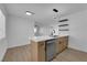 Renovated kitchen features stainless steel appliances, quartz countertops, modern cabinets, and light wood flooring at 1108 Putnam Ave, North Las Vegas, NV 89030