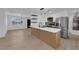 Open kitchen features stainless steel appliances, quartz countertops, modern cabinets, and light wood flooring at 1108 Putnam Ave, North Las Vegas, NV 89030